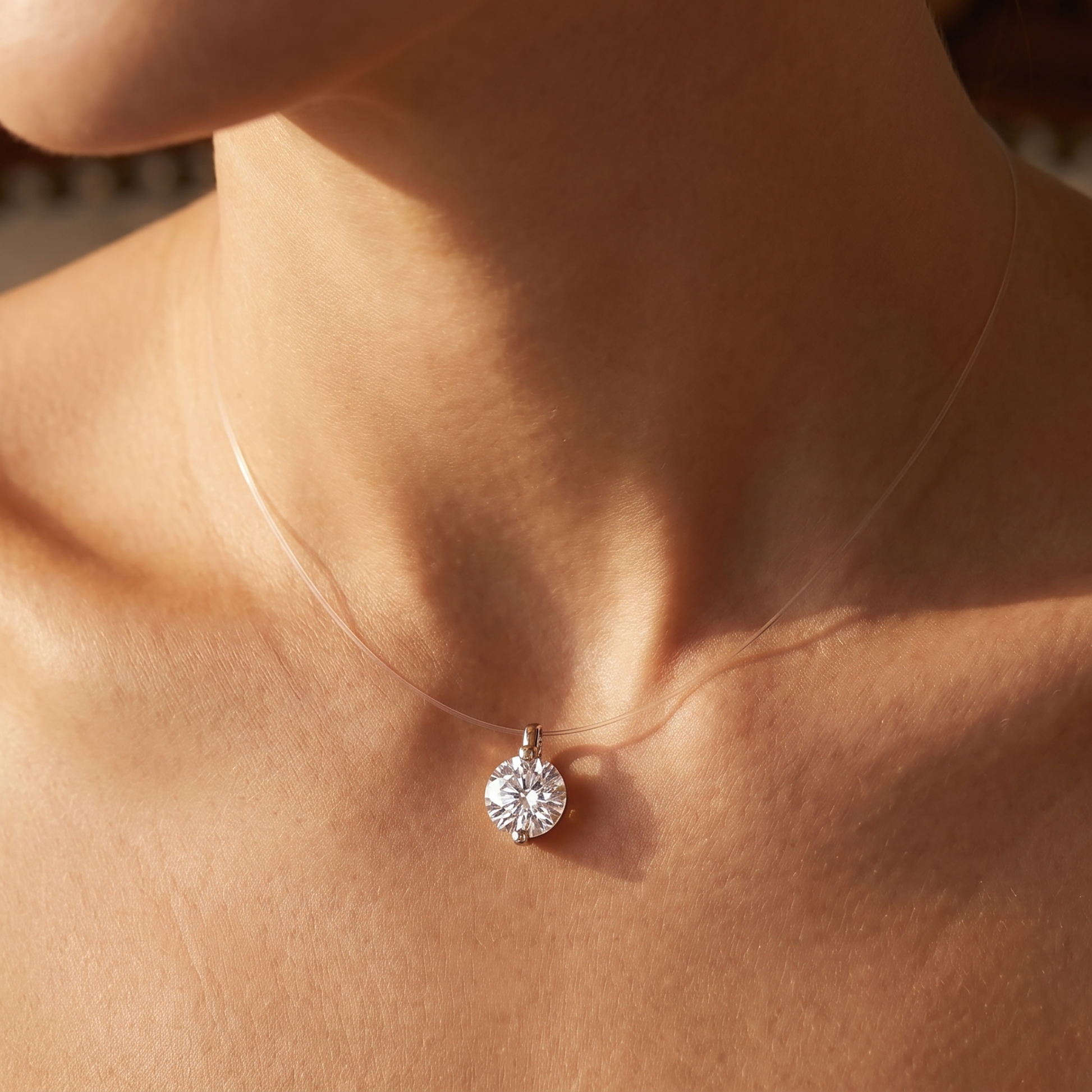 Close-up of solitaire moissanite pendant necklace on warm skin tone