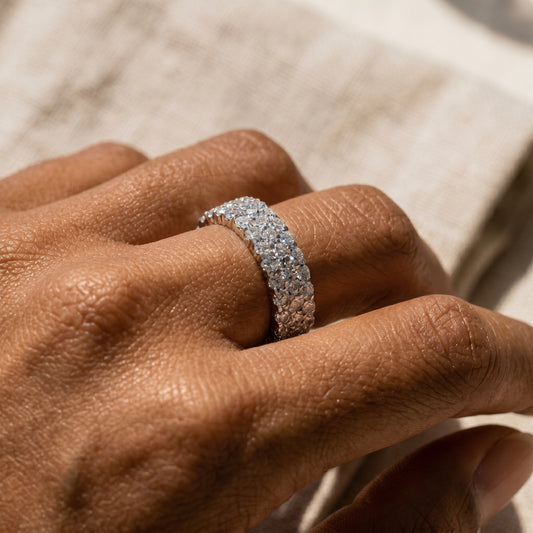 Model wearing a three-row pavé moissanite eternity ring in sterling silver