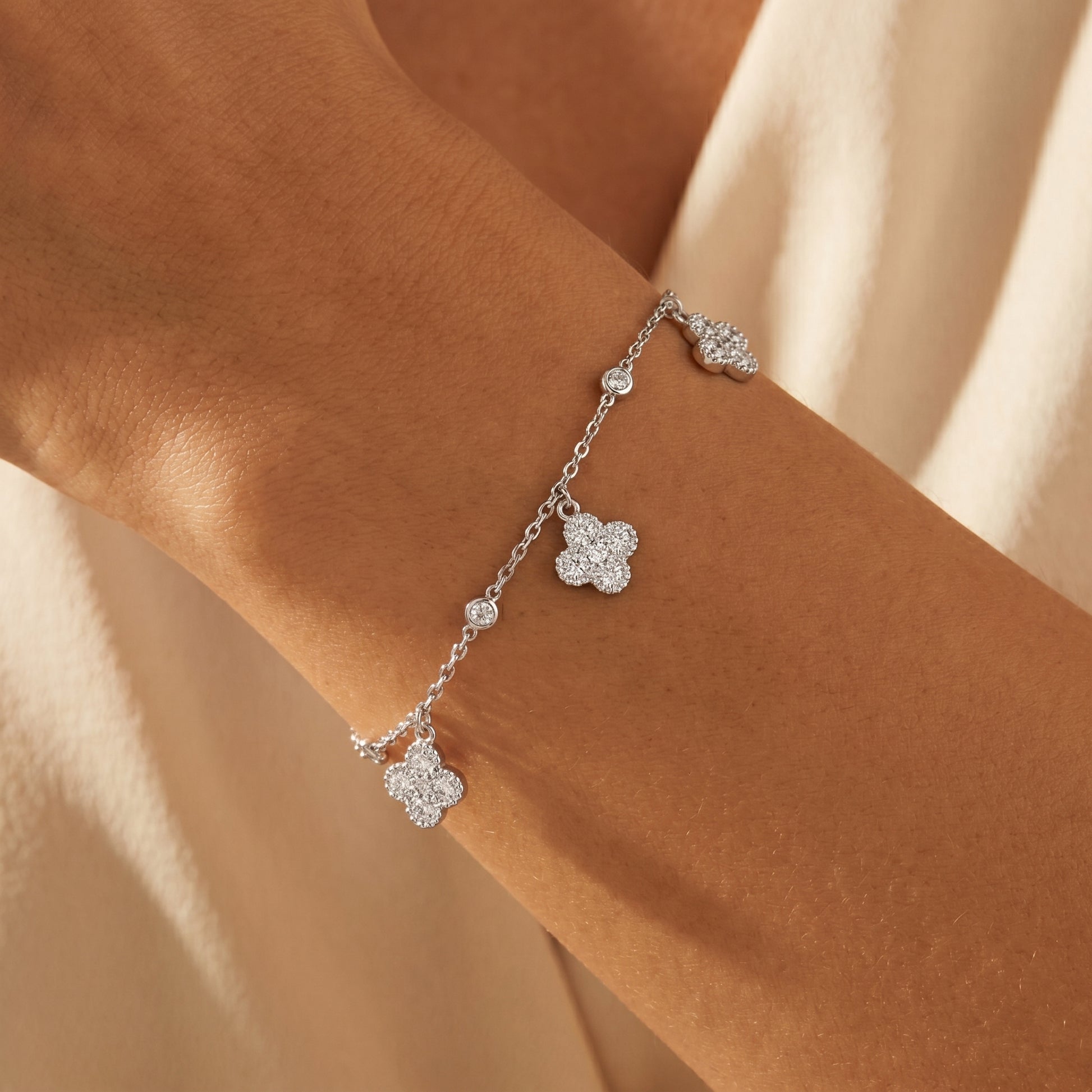 Model wearing a delicate clover moissanite bracelet