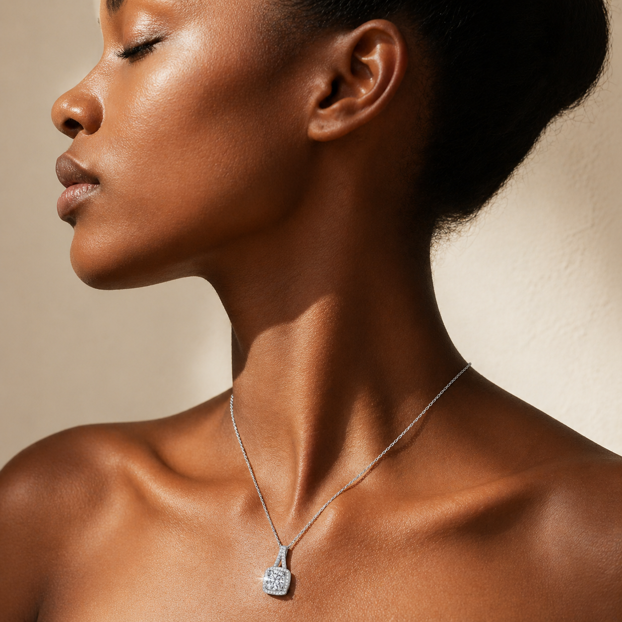 Cushion halo moissanite necklace worn on deep skin tone with elegant side profile