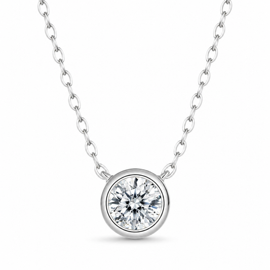 Silver bezel-set round moissanite pendant necklace on white background