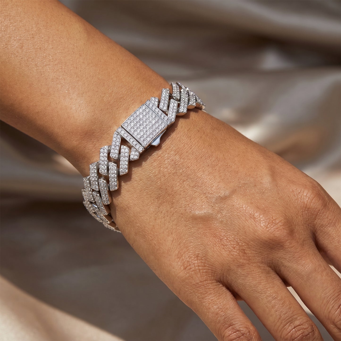 Close-up of a premium structural geometric prong-link moissanite bracelet worn by a model in a minimalist luxury lifestyle setting.