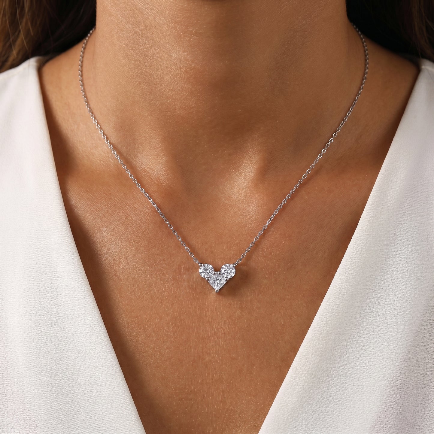 Elegant on-neck look of the 1.0 CT cluster heart moissanite necklace styled with a minimalist dark modern outfit.