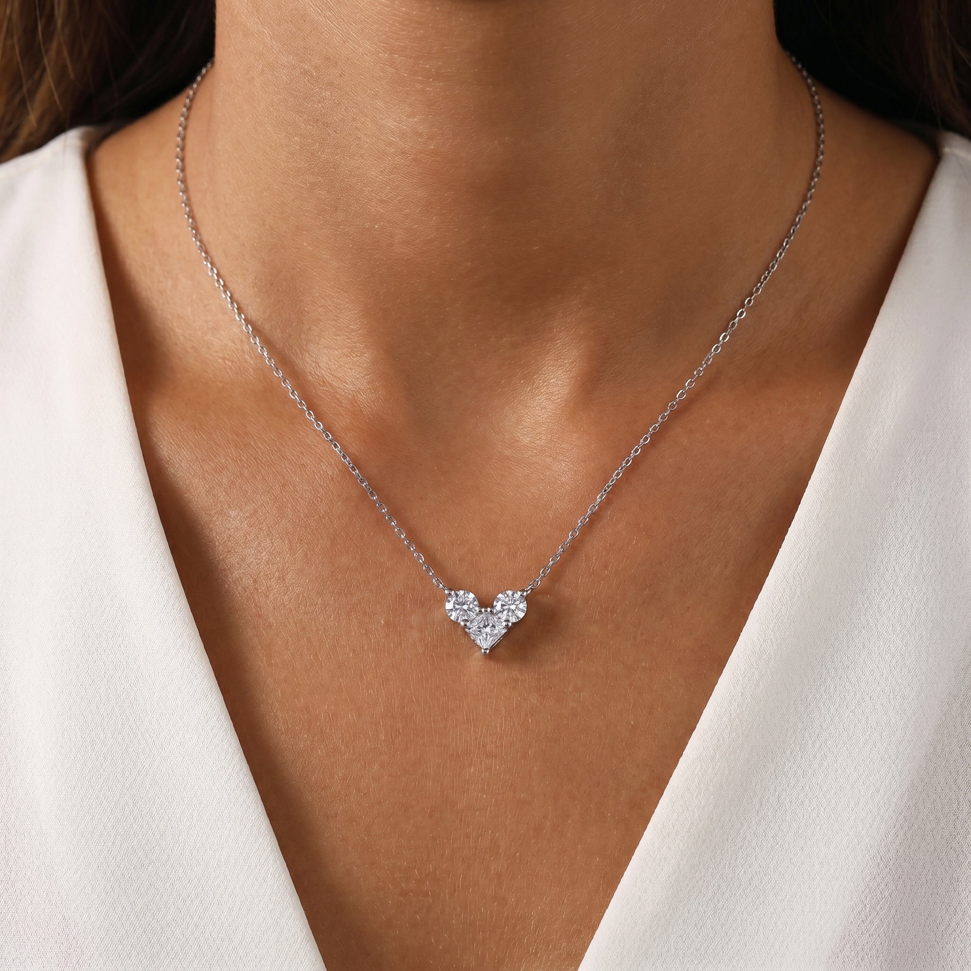 Elegant on-neck look of the 1.0 CT cluster heart moissanite necklace styled with a minimalist dark modern outfit.