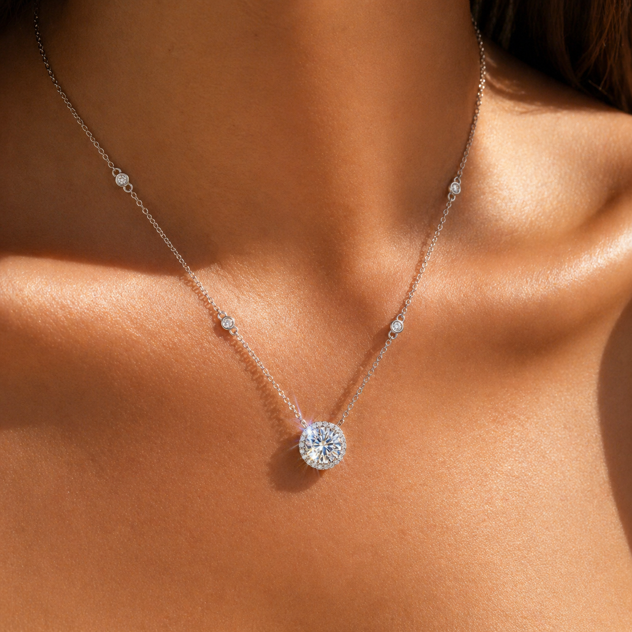 Close-up of round halo moissanite necklace on sun-kissed skin