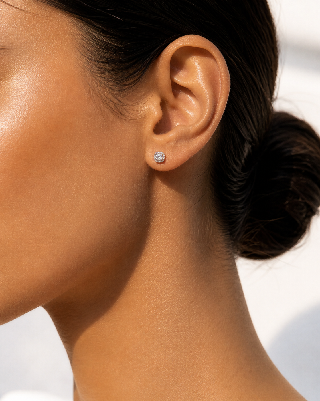 Model wearing 0.3 carat 4.0mm moissanite halo stud earrings for a subtle everyday look.