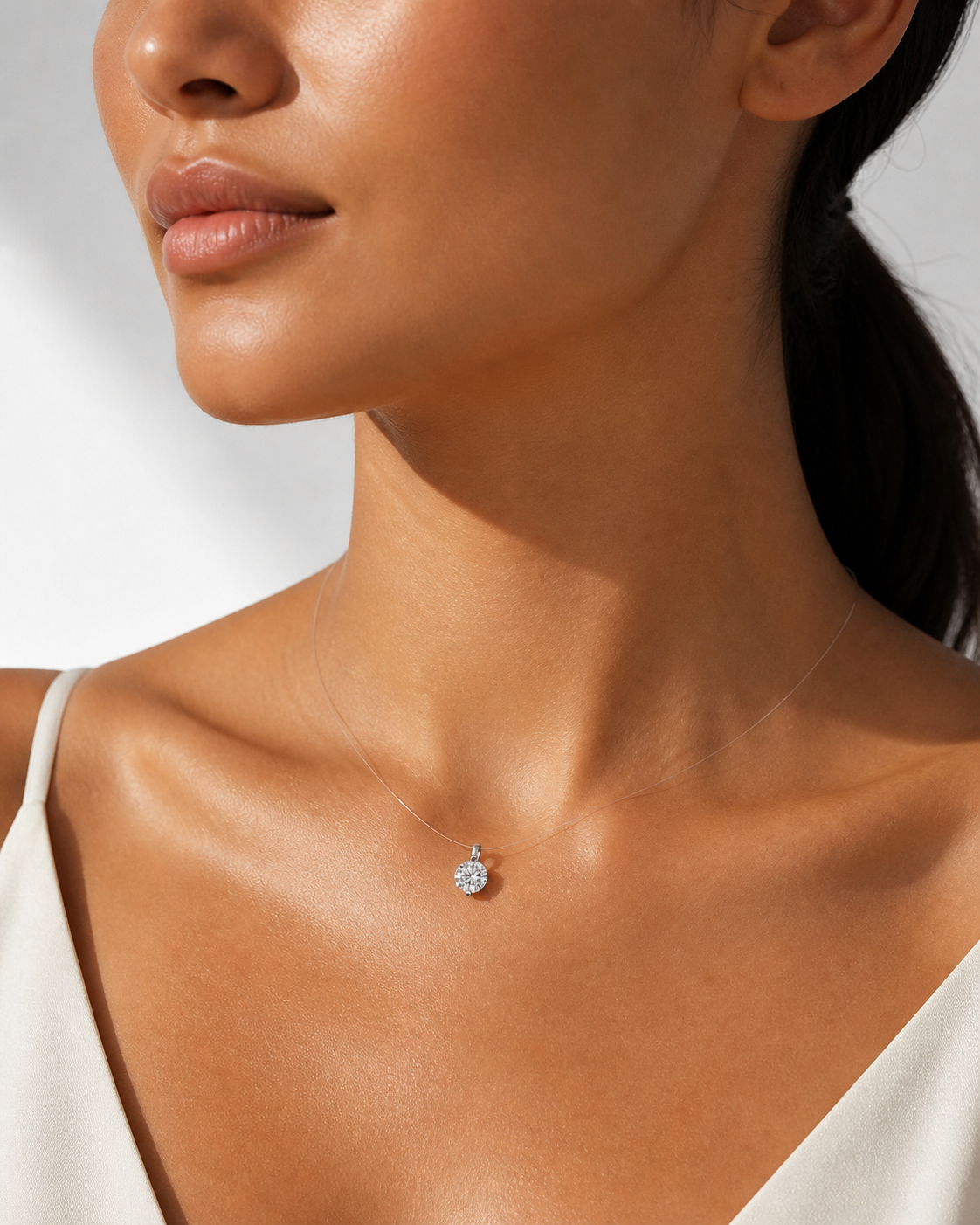 1.0 Carat (6.5mm) solitaire moissanite necklace on sun-kissed skin.