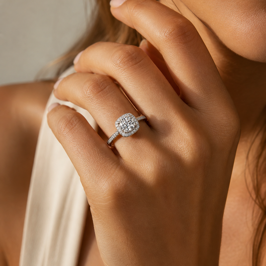 Woman wearing a cushion halo moissanite ring in soft natural sunlight