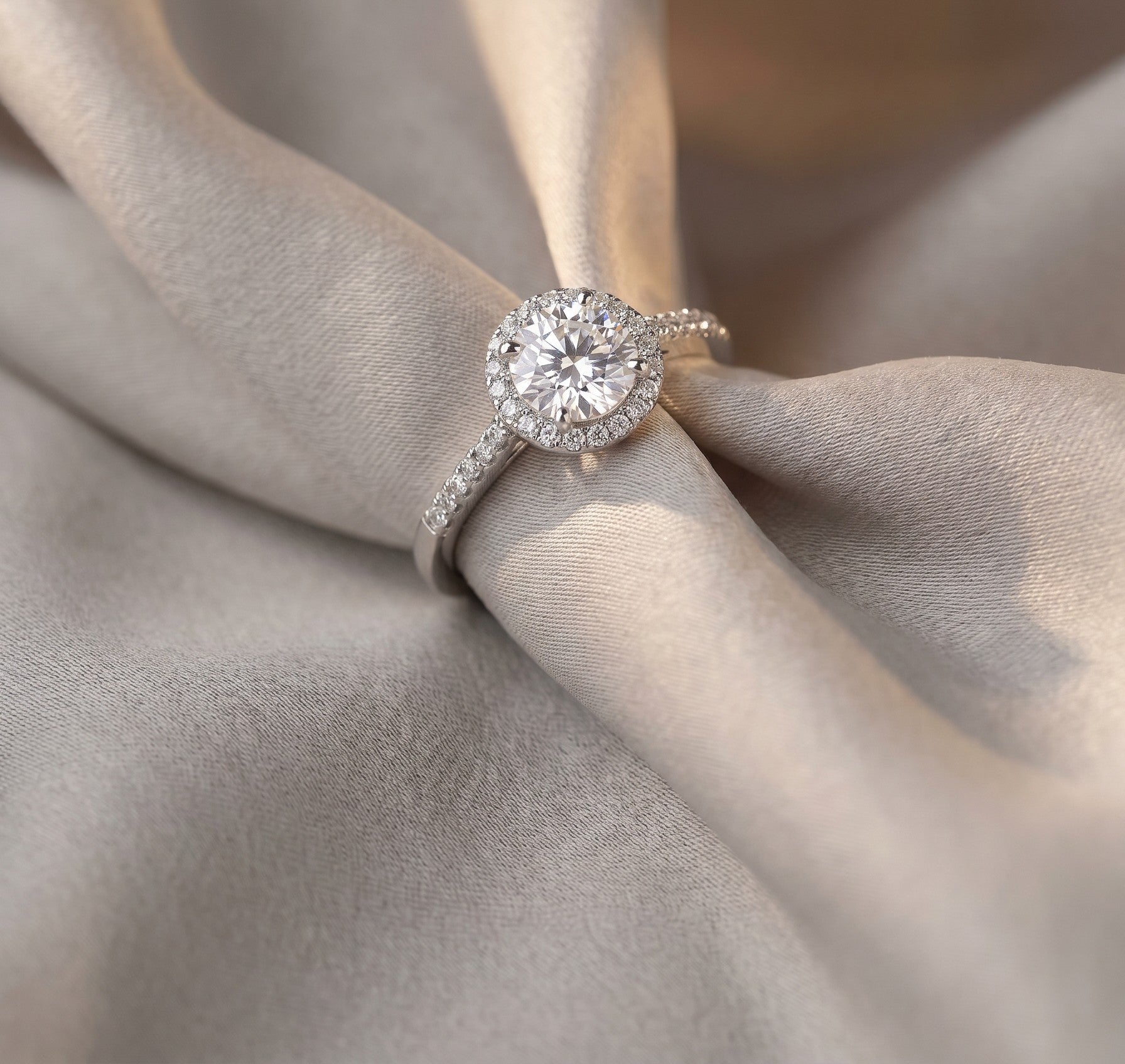 Moissanite engagement style ring in 925 sterling silver on soft neutral silk