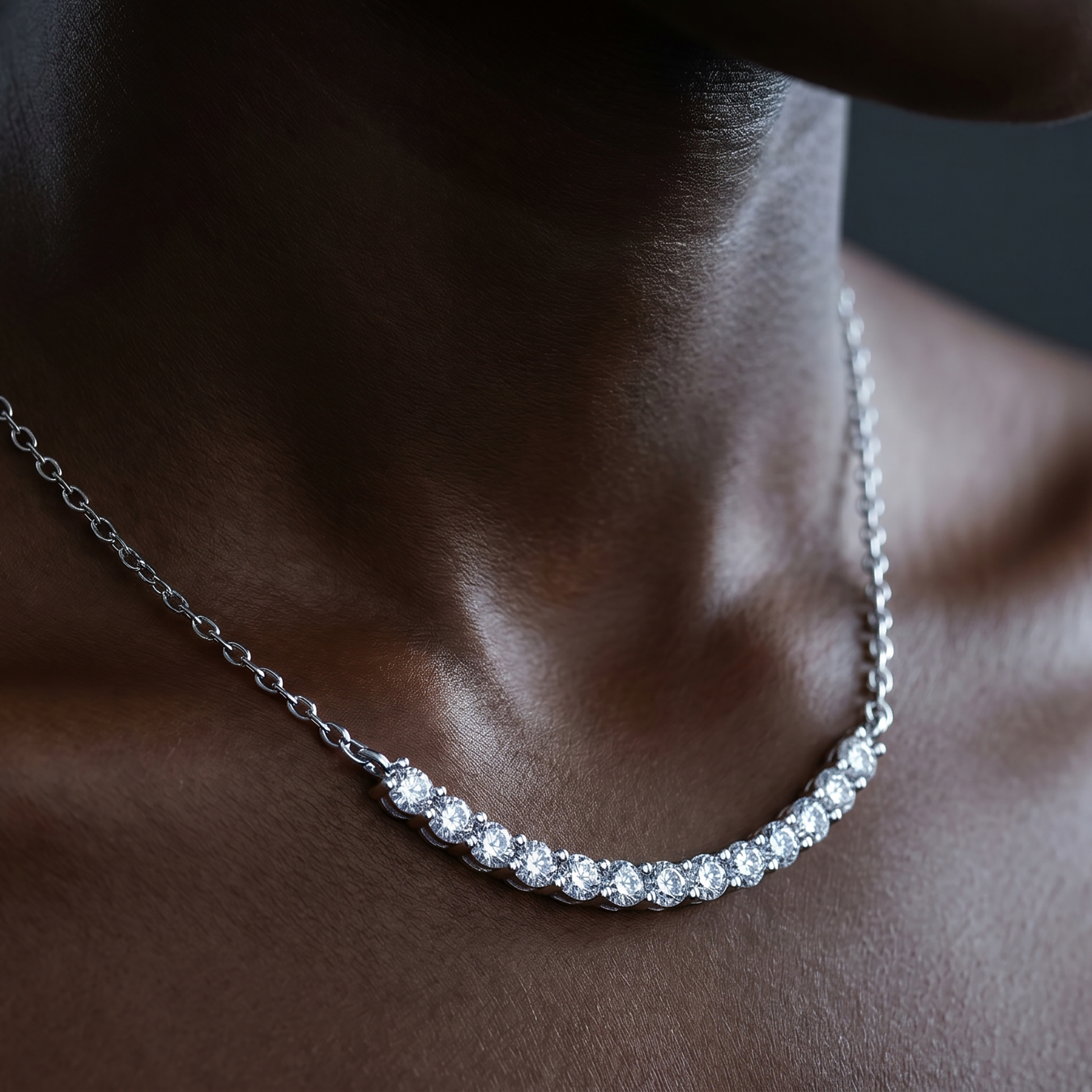 Close-up of curved moissanite bar necklace on deep skin tone