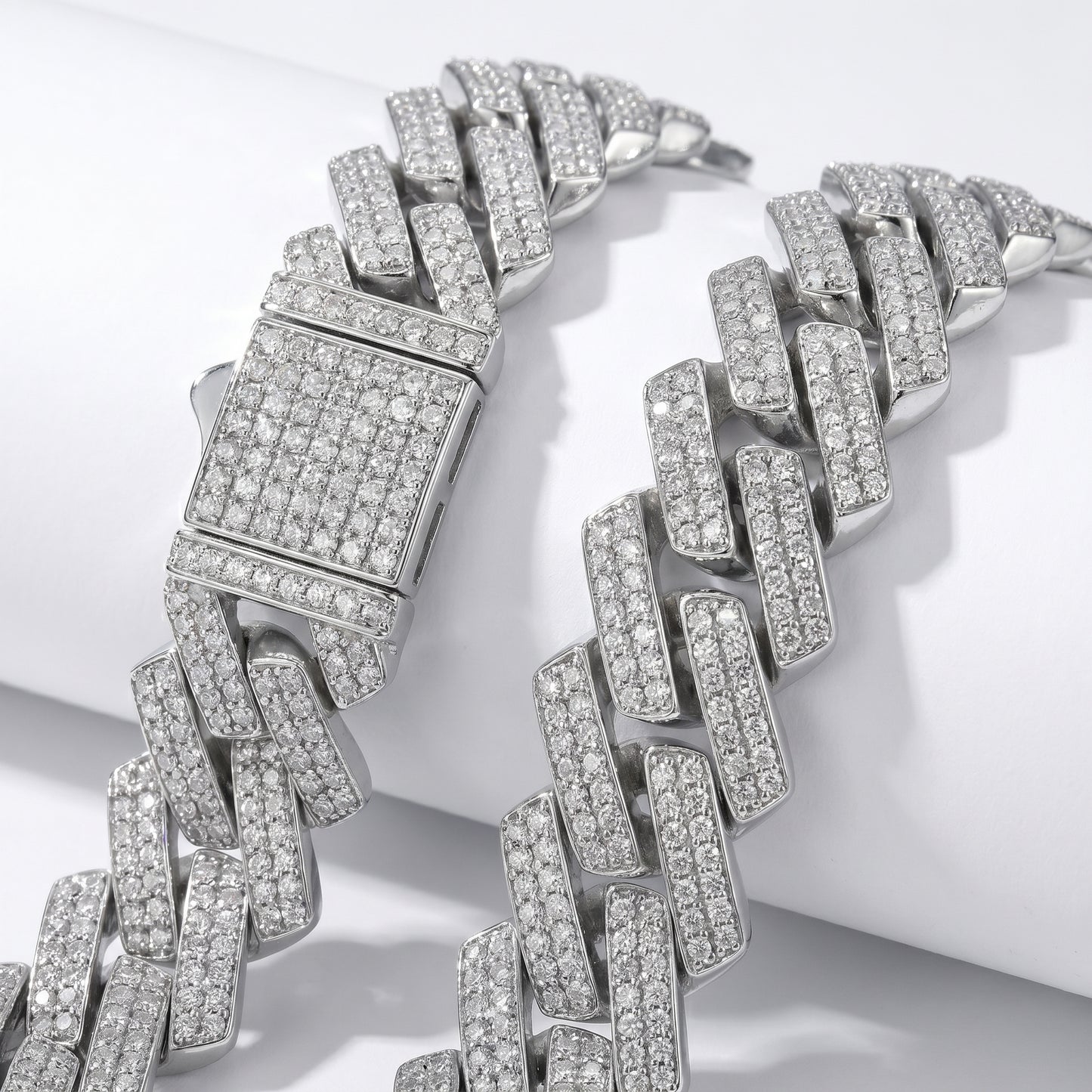 Macro detail of the heavy-duty iced-out box clasp with double safety locks on the Luvia 14mm silver Cuban chain.