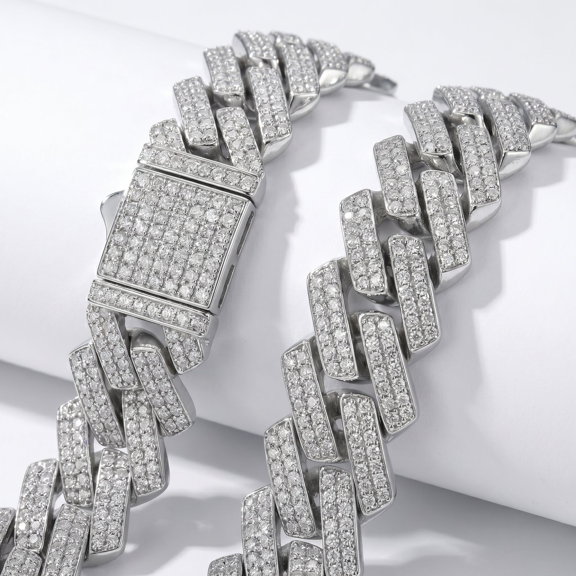 Macro detail of the heavy-duty iced-out box clasp with double safety locks on the Luvia 14mm silver Cuban chain.