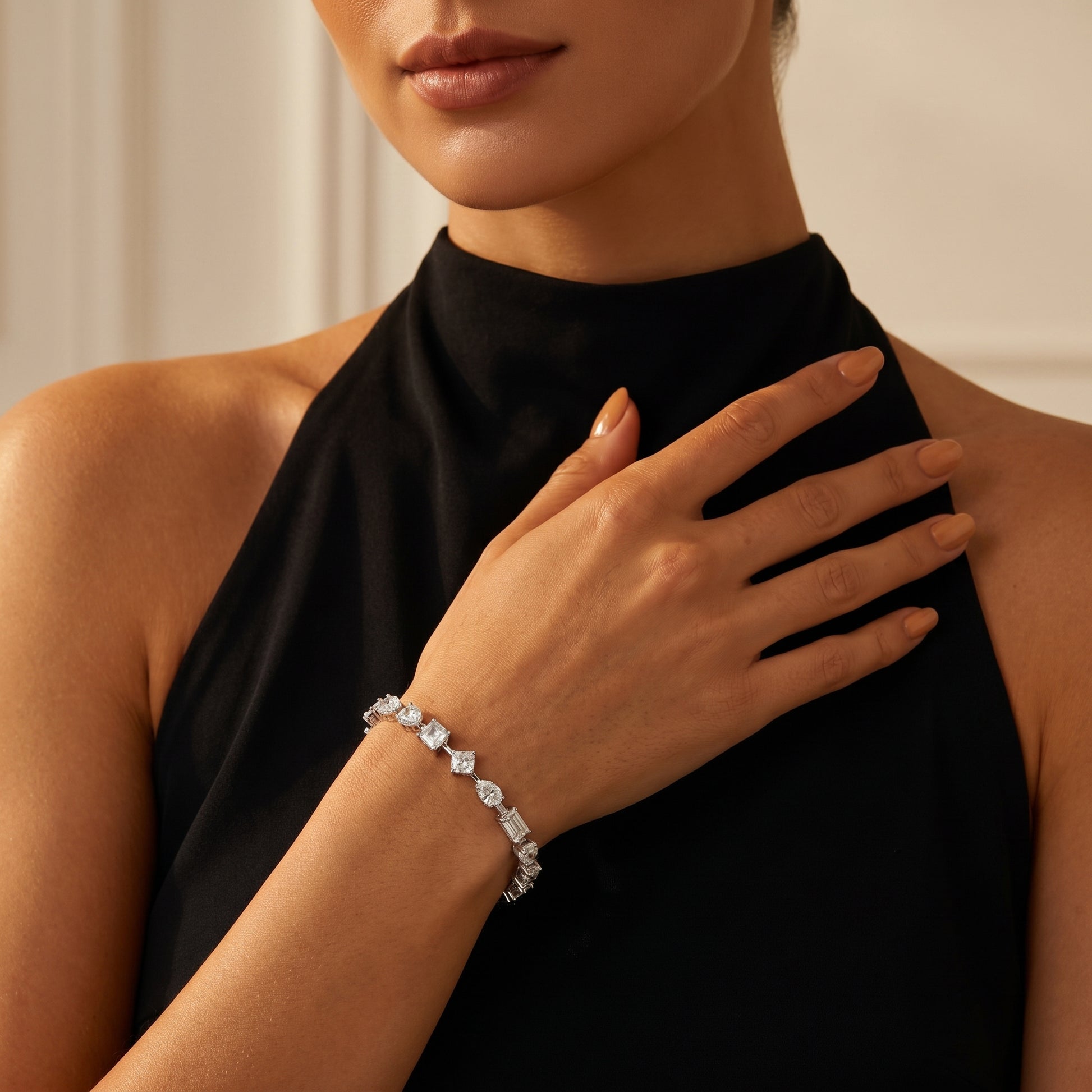 Elegant on-wrist look of Luvia multi-shape moissanite tennis bracelet on tanned skin tone, styled with a modern black dress.