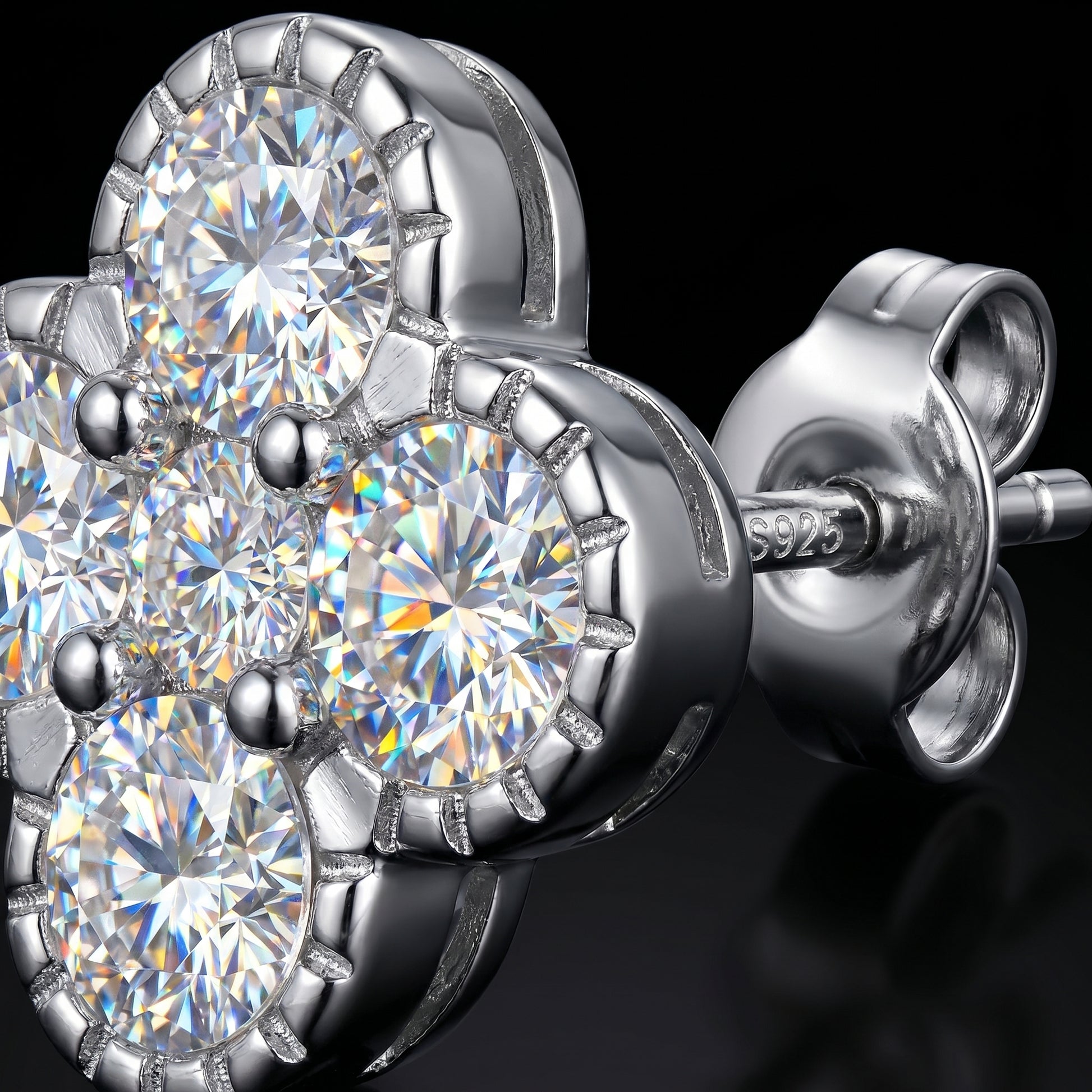 Macro close-up of sterling silver flower moissanite stud earrings showing sparkle and setting details