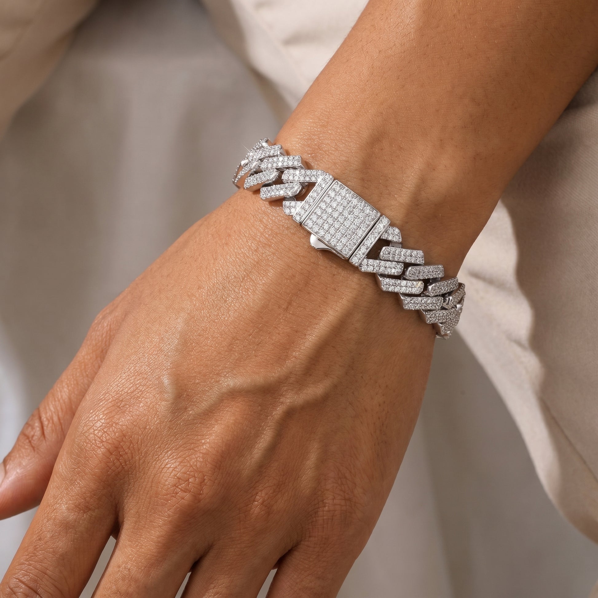 Bold on-wrist look of Luvia 14mm bold moissanite Cuban bracelet displayed on a tanned skin tone model with modern styling.