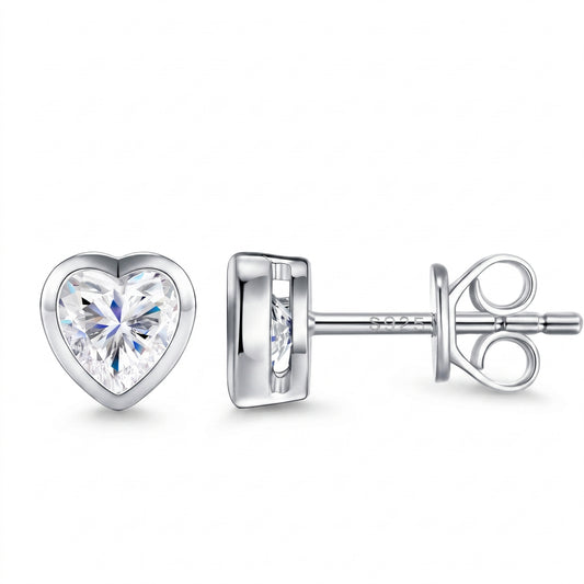 Luvia 1.0 TCW heart cut bezel-set moissanite stud earrings in 18K white gold plated 925 sterling silver.